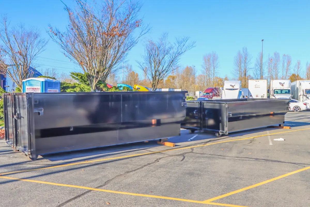 Professional dumpster rental service with roll-off container on residential driveway in Catoosa